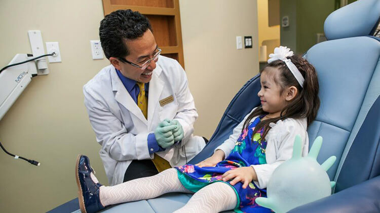 Children's dentist, Dr. Tong with child patient